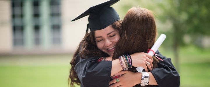 Graduate hugging mother